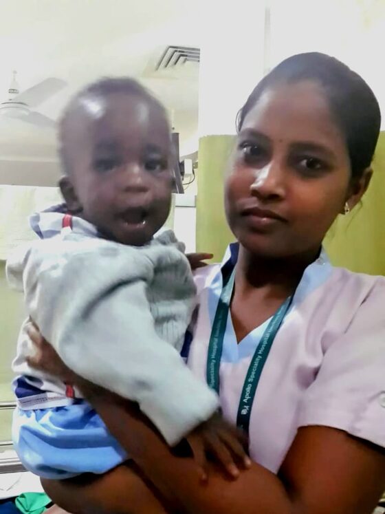 A nurse carries a young patient during his hospital stay.